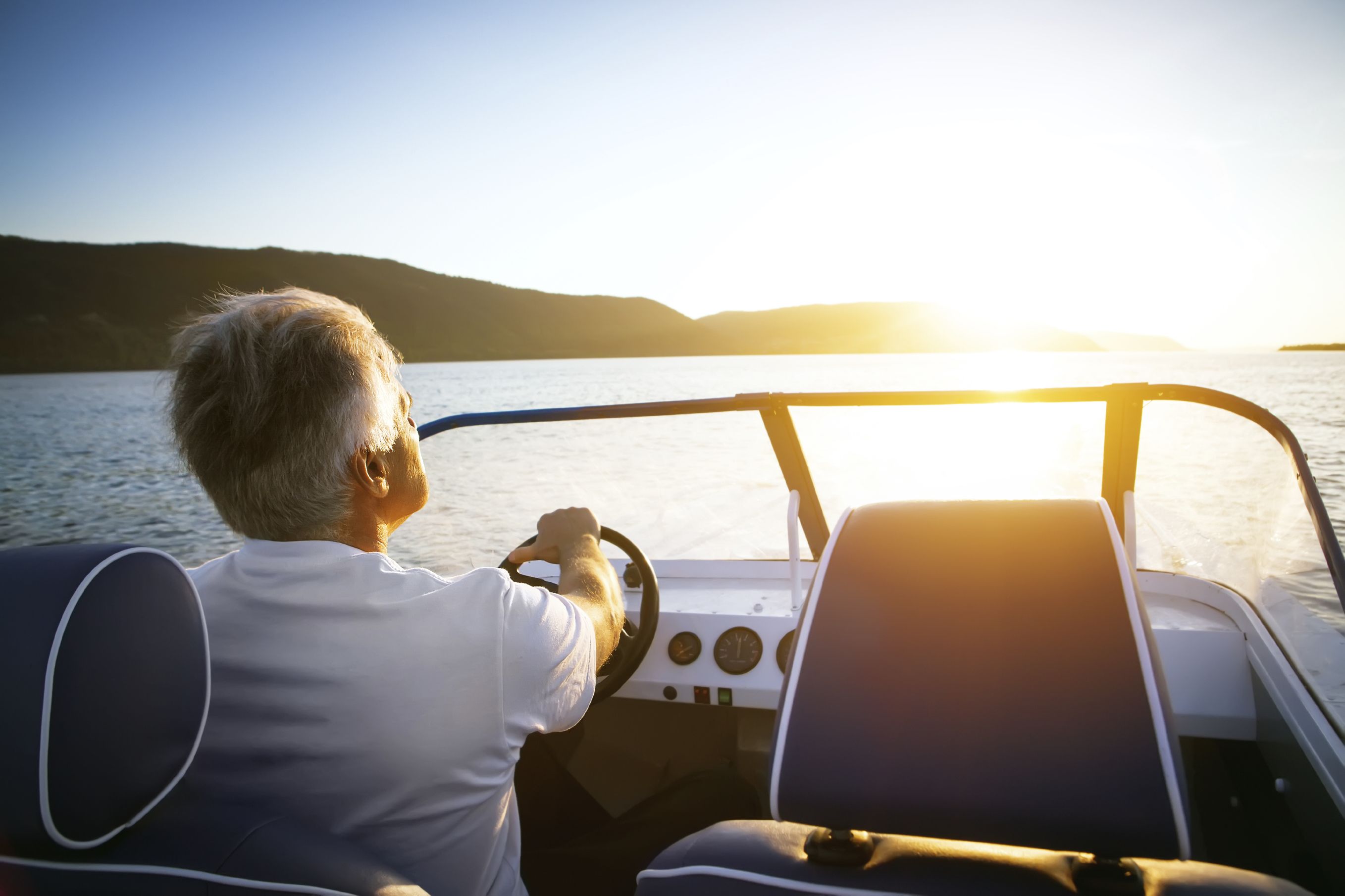 Photo of a man driving a boat